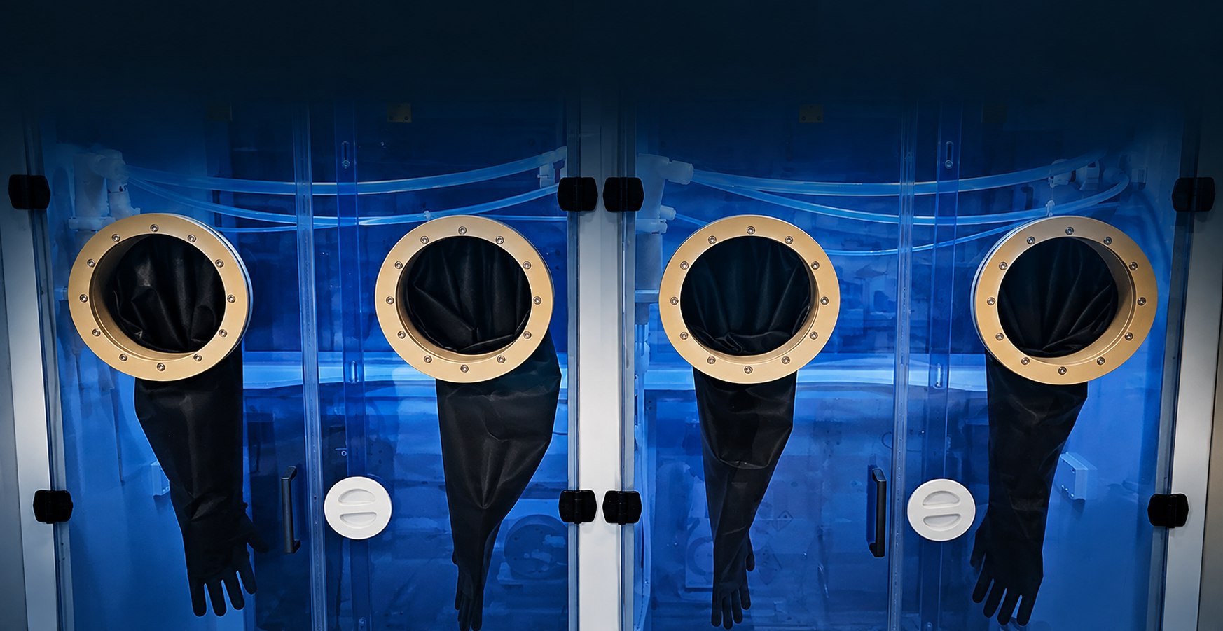 Containment glovebox of the 4Tex bCDS — glove ports in the blue-lit chemical handling chamber